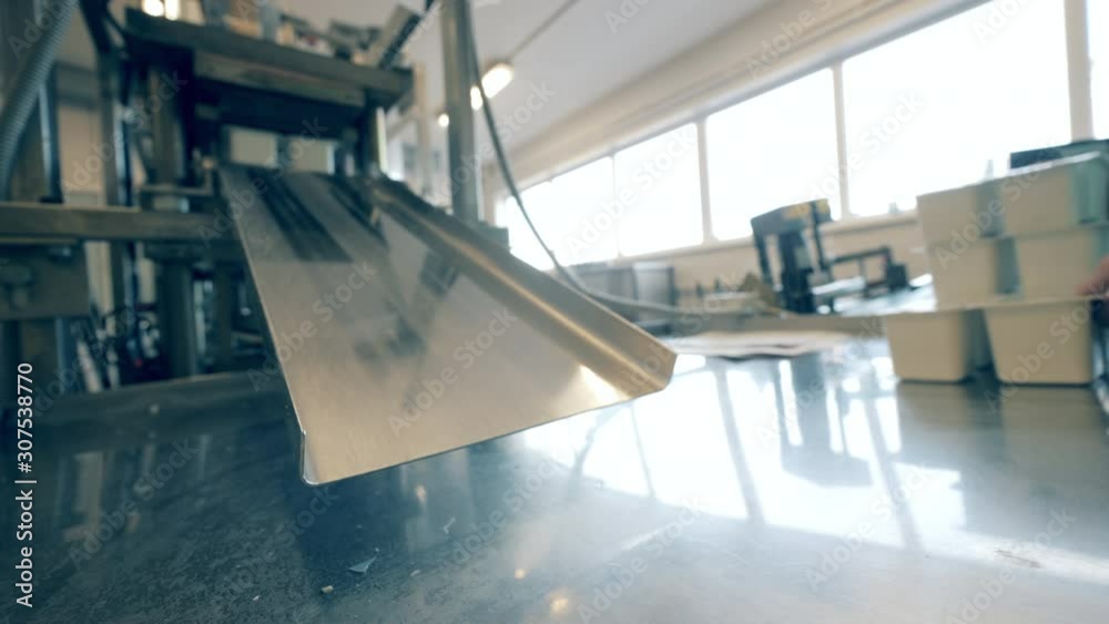 Small boxes with dairy are being released by the conveyor Small boxes with dairy are being released by the conveyor