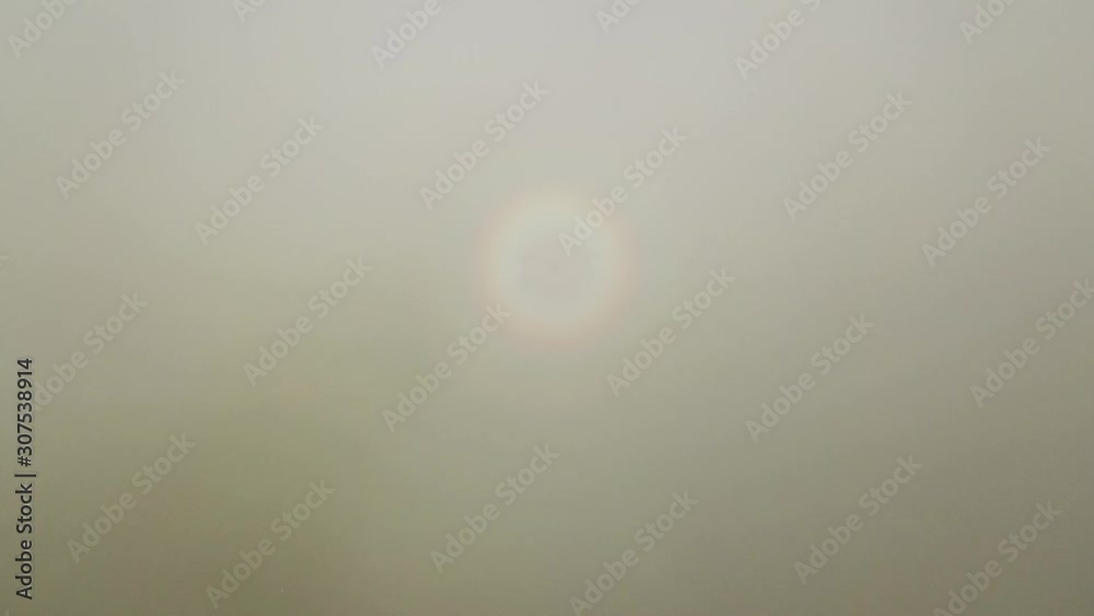 Aerial rainbow halo ring show in the white cloud opposite of sun direction at Malaysia, Southeast Asia. Aerial rainbow halo ring show in the white cloud opposite of sun direction at Malaysia, Southeast Asia.