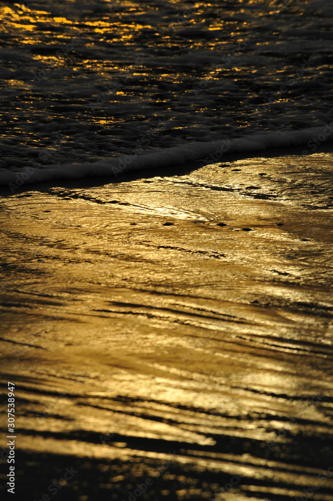 Sunset reflection on the sandy beach Sunset reflection on the sandy beach