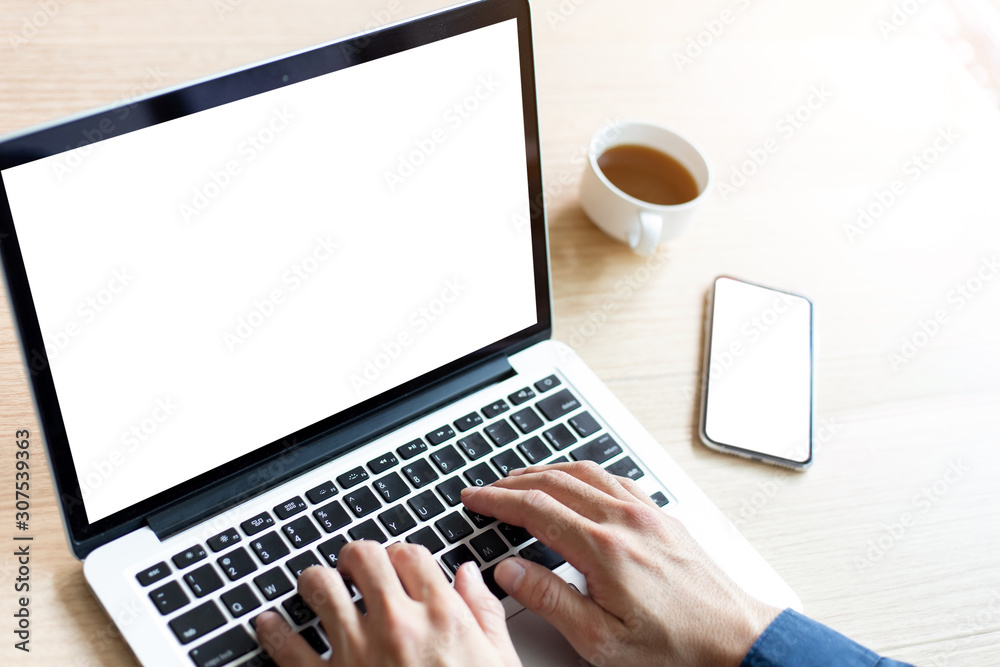 mockup image blank screen computer,cell phone with white background for advertising text,hand man using laptop texting mobile contact business search information on desk in office.marketing and design mockup image blank screen computer,cell phone with white background for advertising text,hand man using laptop texting mobile contact business search information on desk in office.marketing and design