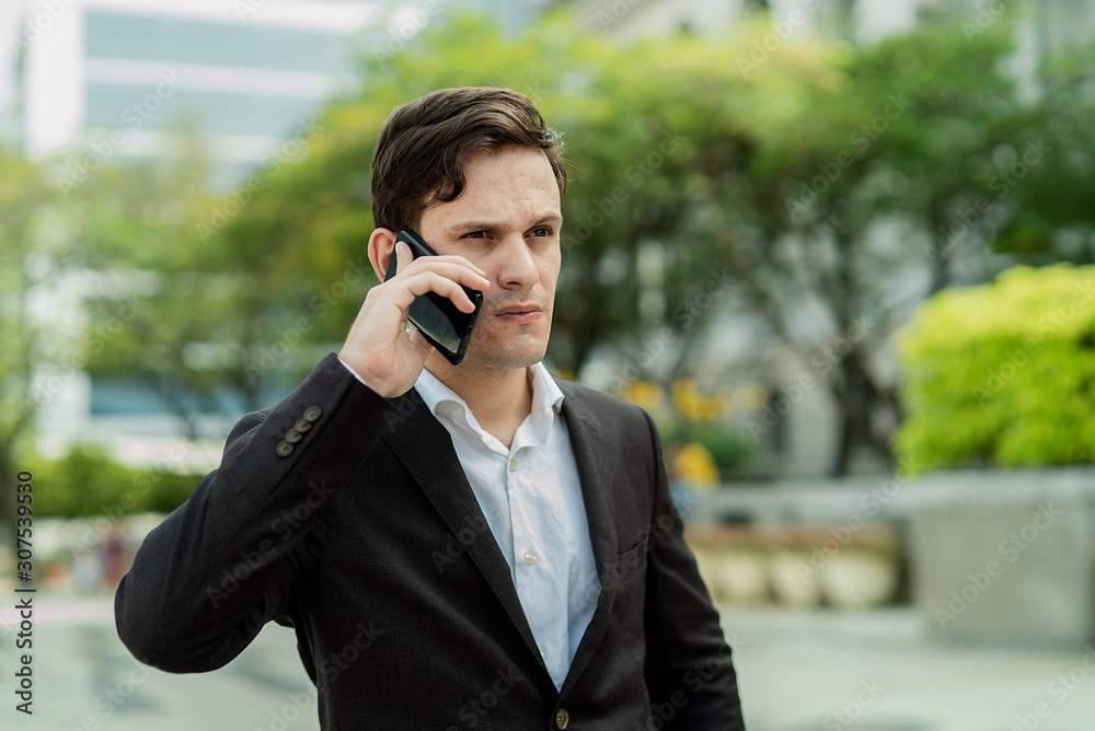 Expression Face Businessman Talking On Mobile Phone Call standing in front building Expression Face Businessman Talking On Mobile Phone Call standing in front building