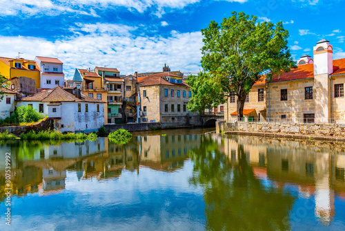 Tableau sur toile Old buildings in Viseu reflected on a local creek, Portugal