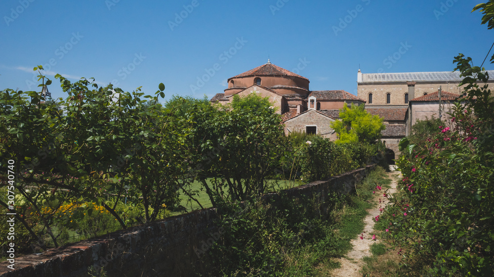 Path leading to Cathedral of Santa Maria Assunta and Church of Santa Fosca on island of Torcello, Venice, Italy