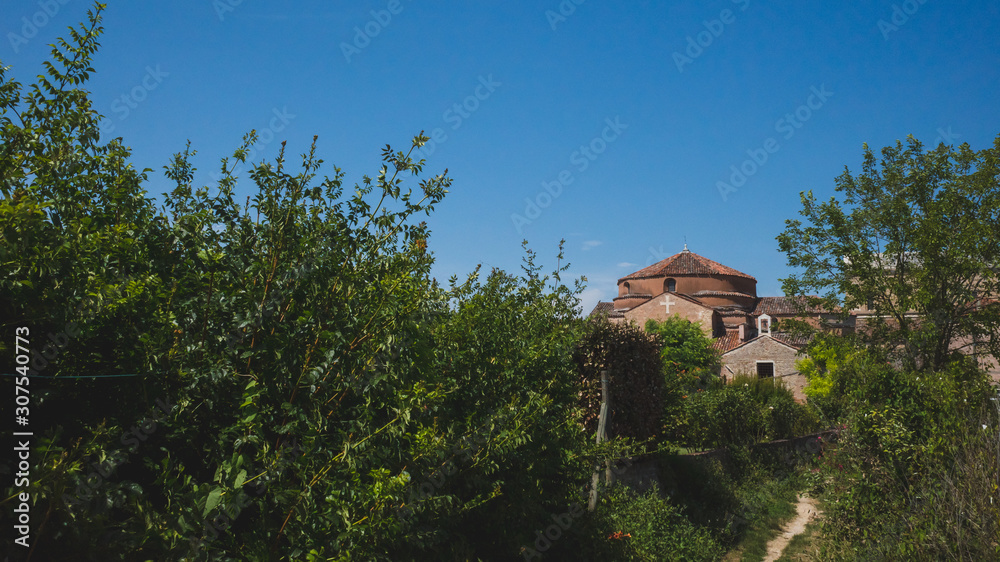 Path leading to Cathedral of Santa Maria Assunta and Church of Santa Fosca on island of Torcello, Venice, Italy