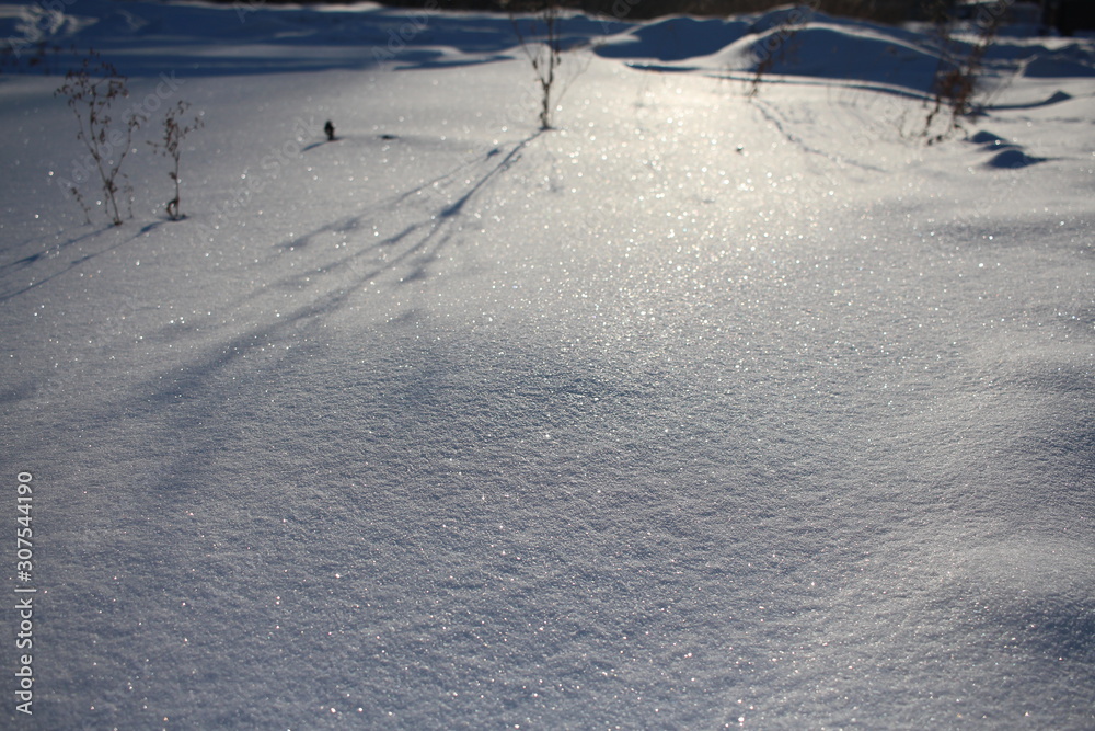 uneven surface of snow cover in winter in nature in the Siberian field