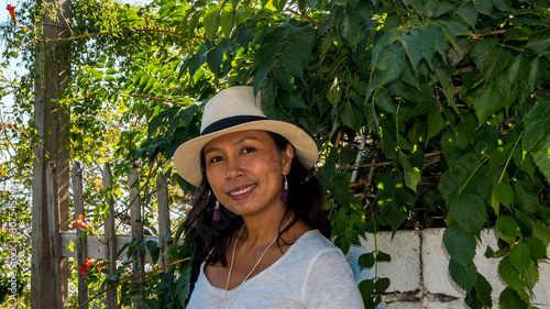 Closeup of Asian woman in white t-shirt and wearing hat in Athens