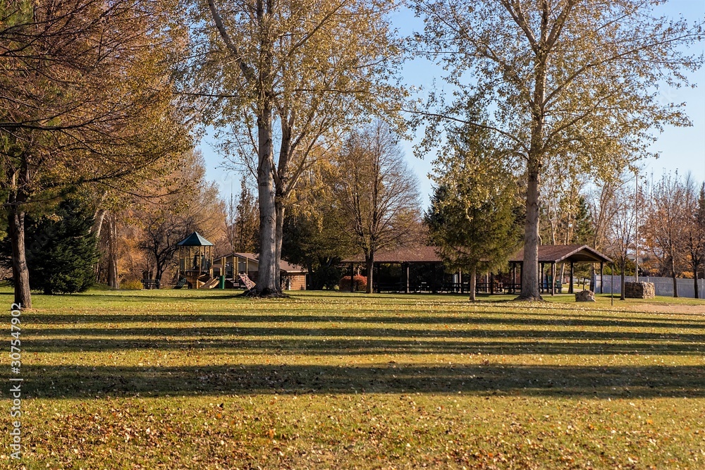 Public parks in autumn with with walking and biking paths, picnic shelters and playgrounds