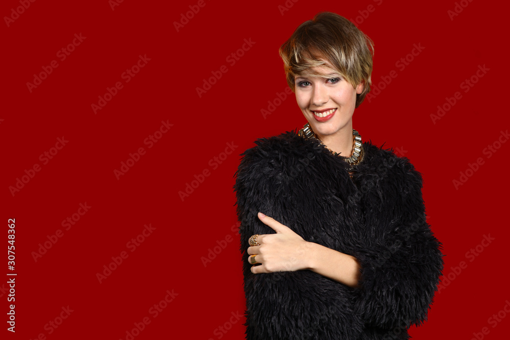 young female model with short hair posing in front of red background young female model with short hair posing in front of red background