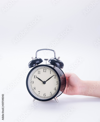 clock or alarm clock with hand on a background new.