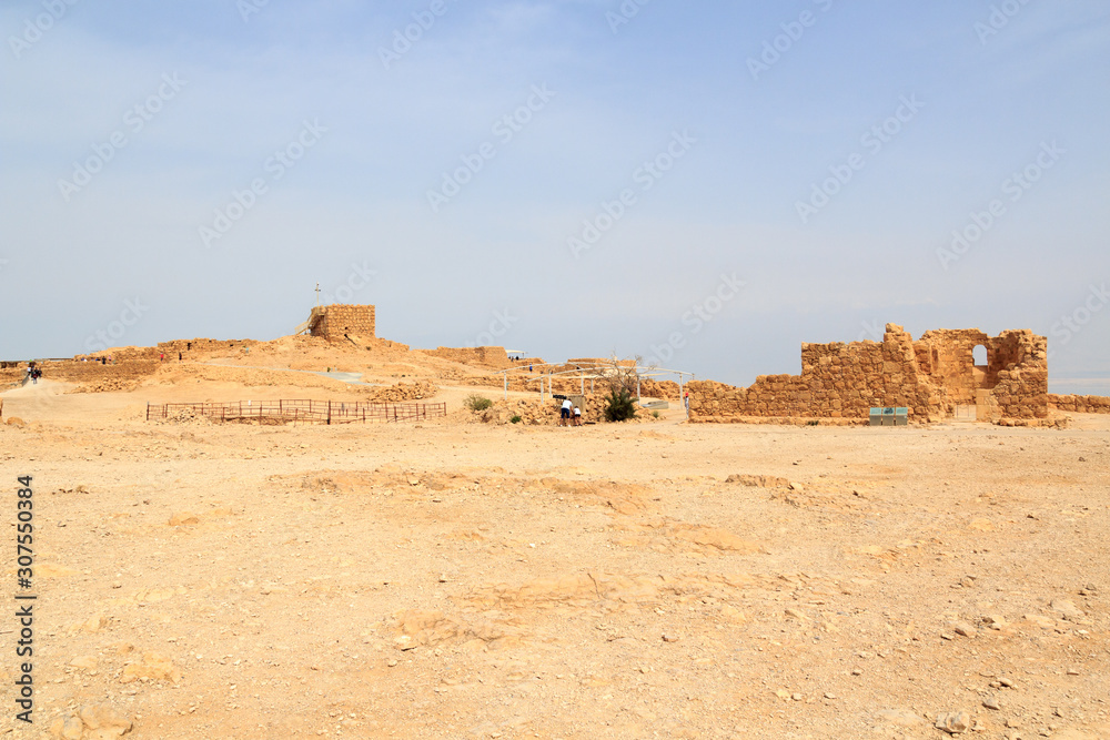 Panorama with ruins of palace and fortress Masada on Judaean Desert rock plateau, Israel