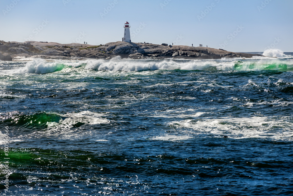 Peggy's Cove, Nova Scotia - A popular tourist's attraction constructed on interesting rock formations with surf breaking in the foreground