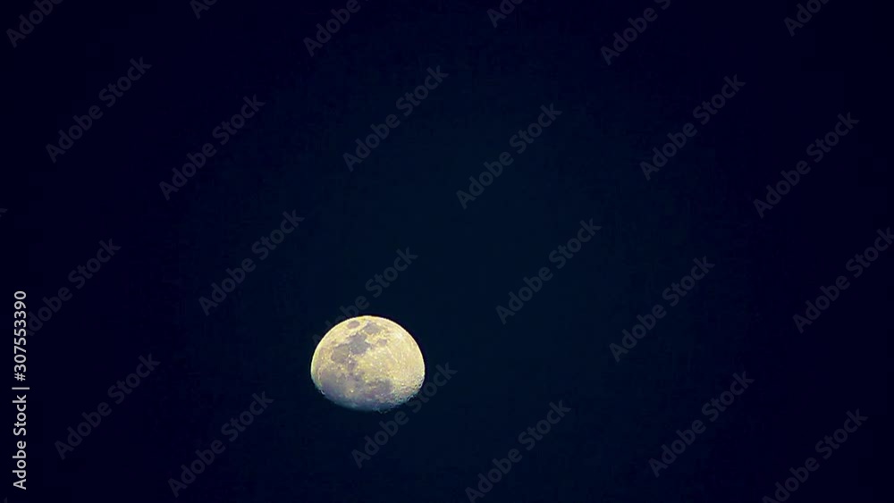 Moon changes colors, yellow, blue, then purple, moves from bottom to to of screen, time lapse. Moon changes colors, yellow, blue, then purple, moves from bottom to to of screen, time lapse.