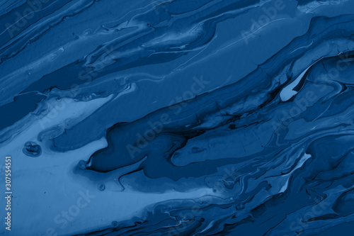 Photography on the theme of the trend color 2020. Abstract handmade composition made using fluid art technique on a real art canvas.