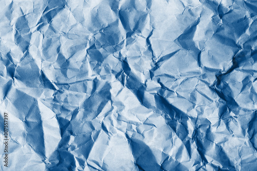 Texture of crumpled paper. Trendy blue background.