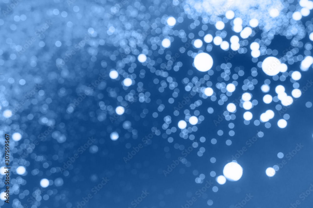 Abstract dark blue colored blured sparkling background. Color of the year 2020. Main color trend concept.