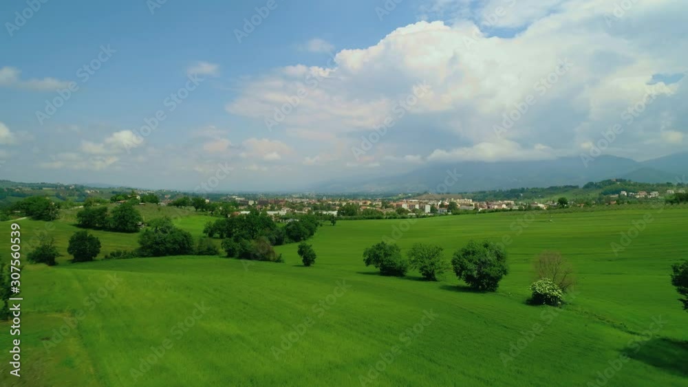 Aerial low flight over olive groves toward the small Italian town of Spoleto Italy during a sunny summer day Aerial low flight over olive groves toward the small Italian town of Spoleto Italy during a sunny summer day