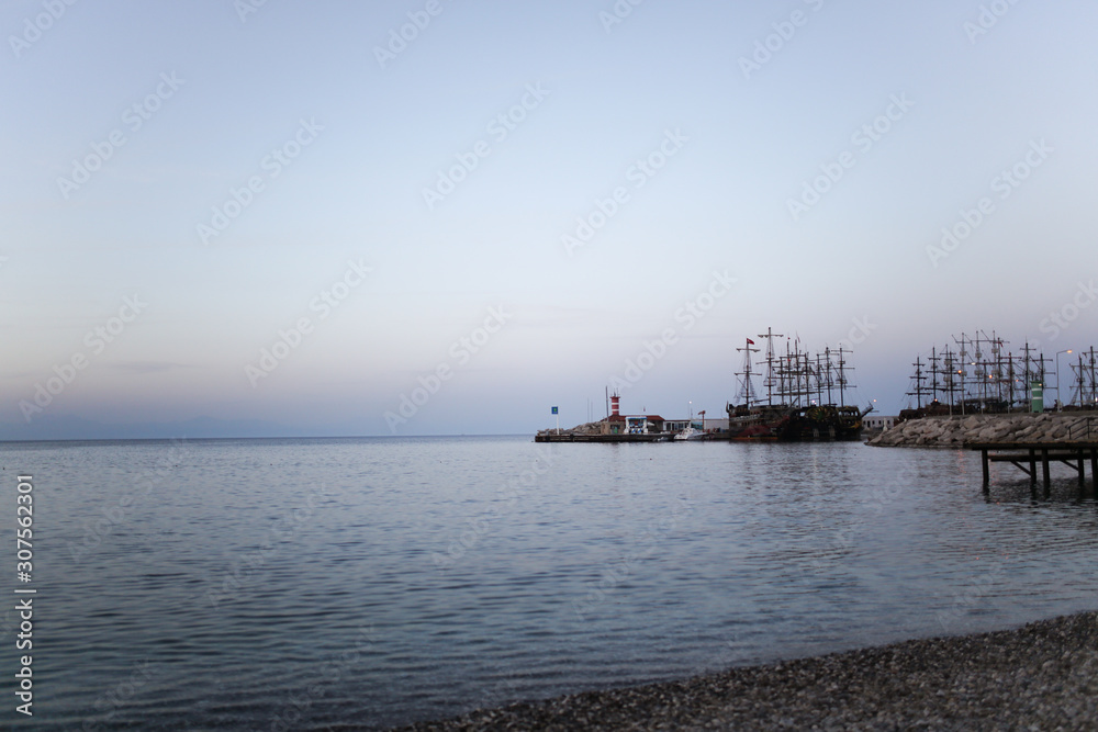 Ships and lighthouse at sea at dusk, Turkey Ships and lighthouse at sea at dusk, Turkey