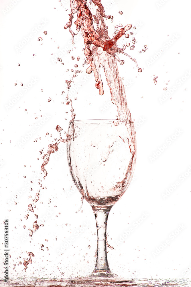 pouring red wine into a glass, strong flow and splash pouring red wine into a glass, strong flow and splash