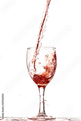 pouring red wine into a glass, strong flow and splash