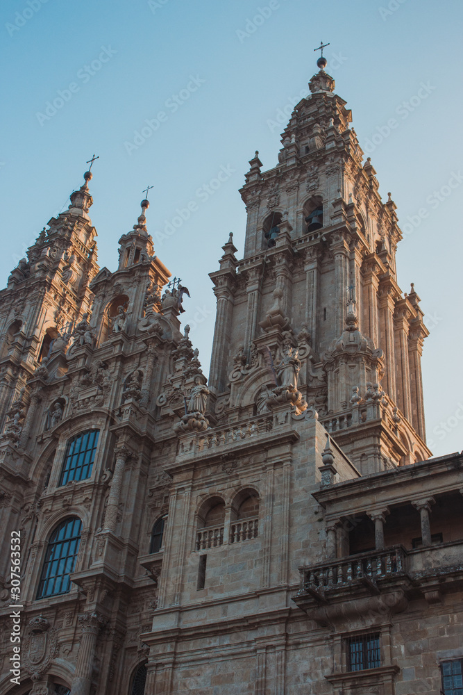Famous Cathedral of Saint James in Santiago de Compostela, Spain. Catholic church in the morning light on blue sky background. Pilgrimage centre. Religious heritage. Medieval architecture.
