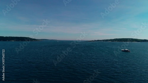 Aerial push over an inlet near Casco Bay over a monohull fishing boat vessel on Chebeague Island Maine