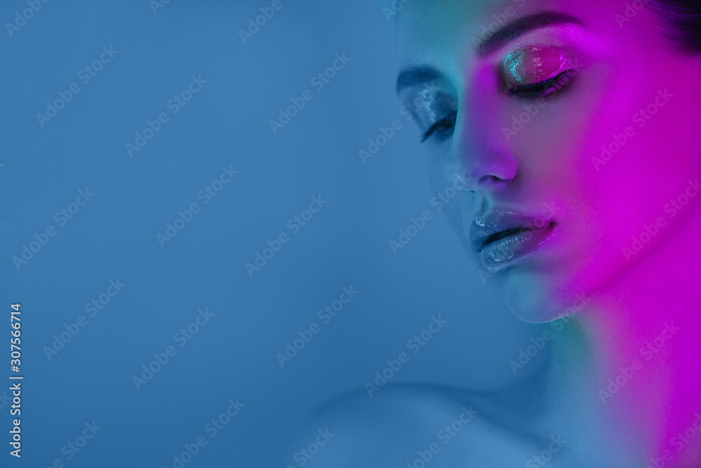 High Fashion model girl in neon lights posing in studio, portrait of beautiful woman, trendy glowing make-up. Art design colorful make up. High Fashion model girl in neon lights posing in studio, portrait of beautiful woman, trendy glowing make-up. Art design colorful make up.
