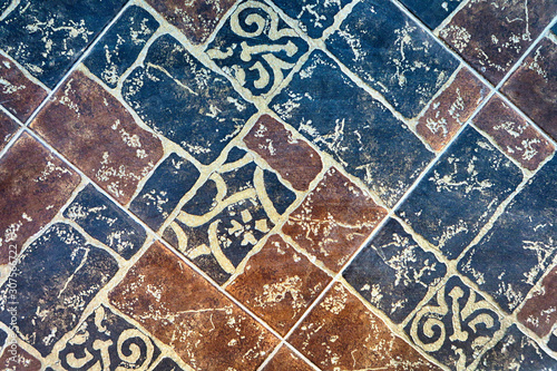 The texture of the stone on the tile. Abstract pattern on the wall close-up. Marble floor. Green, red multi-colored tile Pattern for decoration design. Seamless pattern for clipart.