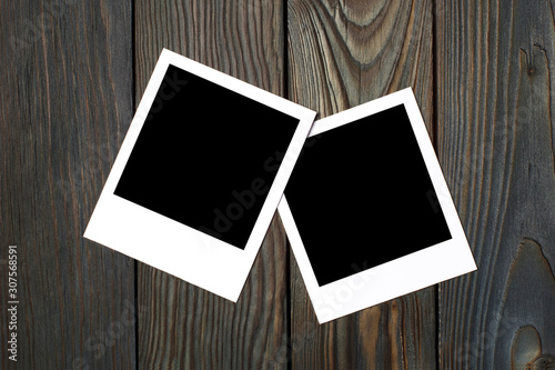 Two square blank photocards on dark wooden background photo