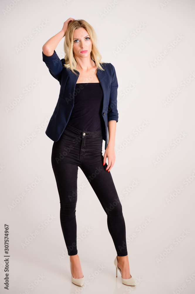 Business work concept. Full-length portrait of a pretty woman accountant - financier with excellent makeup, beautiful hair on a white background standing in front of the camera. Business work concept. Full-length portrait of a pretty woman accountant - financier with excellent makeup, beautiful hair on a white background standing in front of the camera.