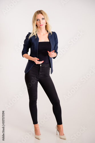 Business work concept. Full-length portrait of a pretty woman accountant - financier with excellent makeup, beautiful hair on a white background standing in front of the camera.