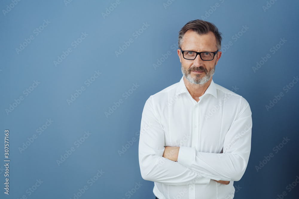 Man in glasses and white shirt with arms crossed Man in glasses and white shirt with arms crossed