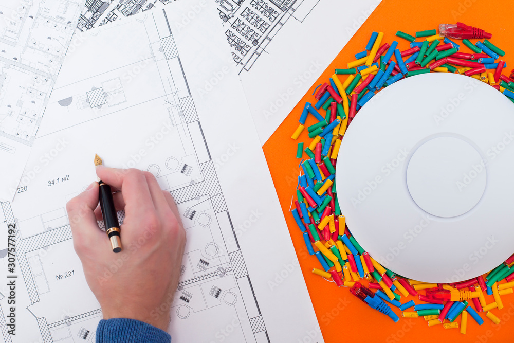 Engineering process. Man developing a network diagram for wifi access ...