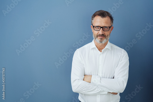 Man in glasses and white shirt with arms crossed