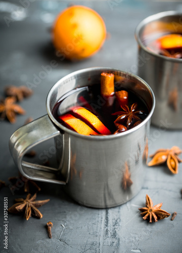 Mulled red wine in metal mug on the gray rustic background. Selective focus. Shallow depth of field.