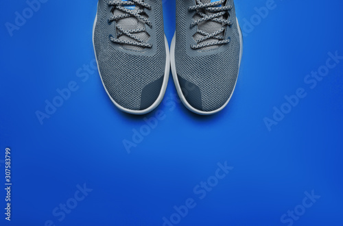 One Pair of blue sport shoes on Classic Blue color of the year 2020 background