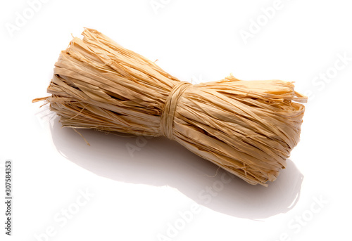 Roll of natural raffia on a white background photo