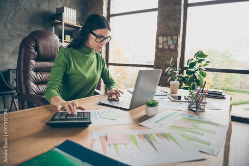Portrait of her she nice attractive experienced professional girl agent broker executive assistant calculating income profit at modern loft industrial interior workplace station