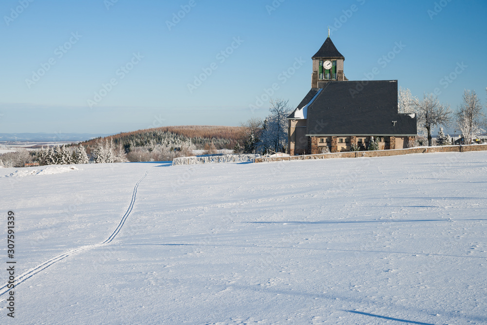 little village with a church in the winter