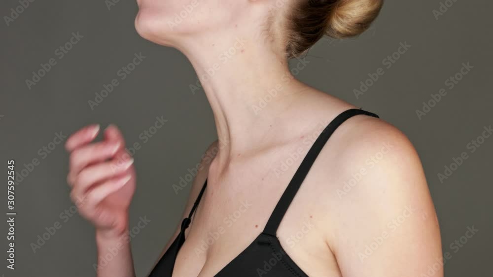 Brunette Wearing A Black Bra Strikes A Pose By Holding Her Neck - Close Up Shot Brunette Wearing A Black Bra Strikes A Pose By Holding Her Neck - Close Up Shot