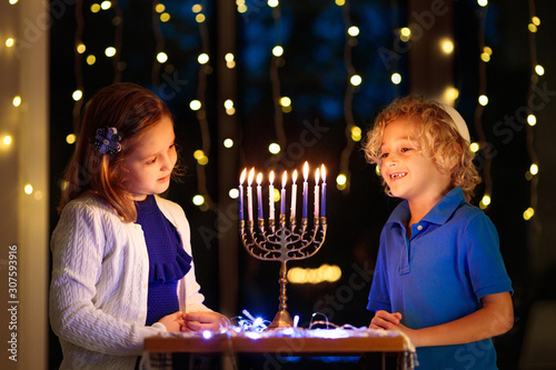 Kids celebrating Hanukkah. Festival of lights. photo