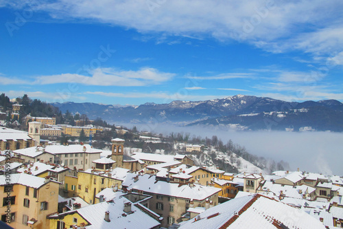 Panorama of Bergamo old town with mountain range behind. Winter scenery.