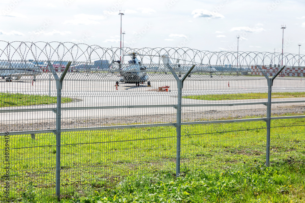 Field at the airport with appliances behind the fence. Field at the airport with appliances behind the fence.