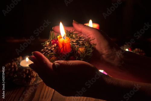  burning candle on the palms of an elderly woman.