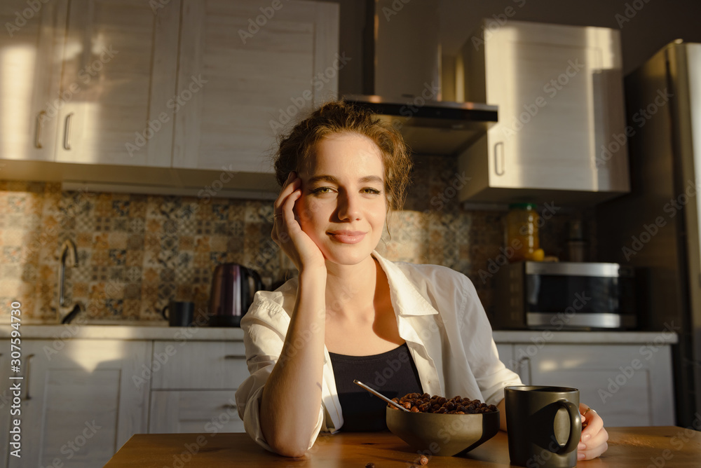 Young attractive girl eats breakfast in the kitchen Young attractive girl eats breakfast in the kitchen