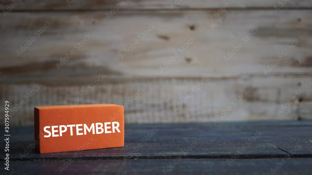september 11th. Day 11 of month, calendar on a color cubes. hand puts the day of the month on the name of the month on a wooden background autumn, day of the year concept