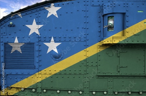 Solomon Islands flag depicted on side part of military armored tank closeup. Army forces conceptual background photo