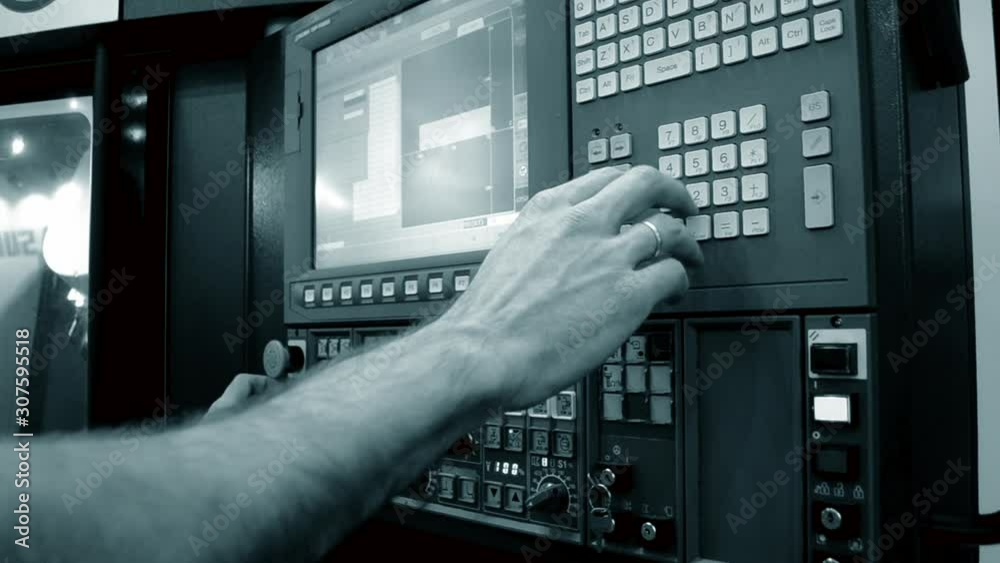 Person works behind the control panel of the production machine