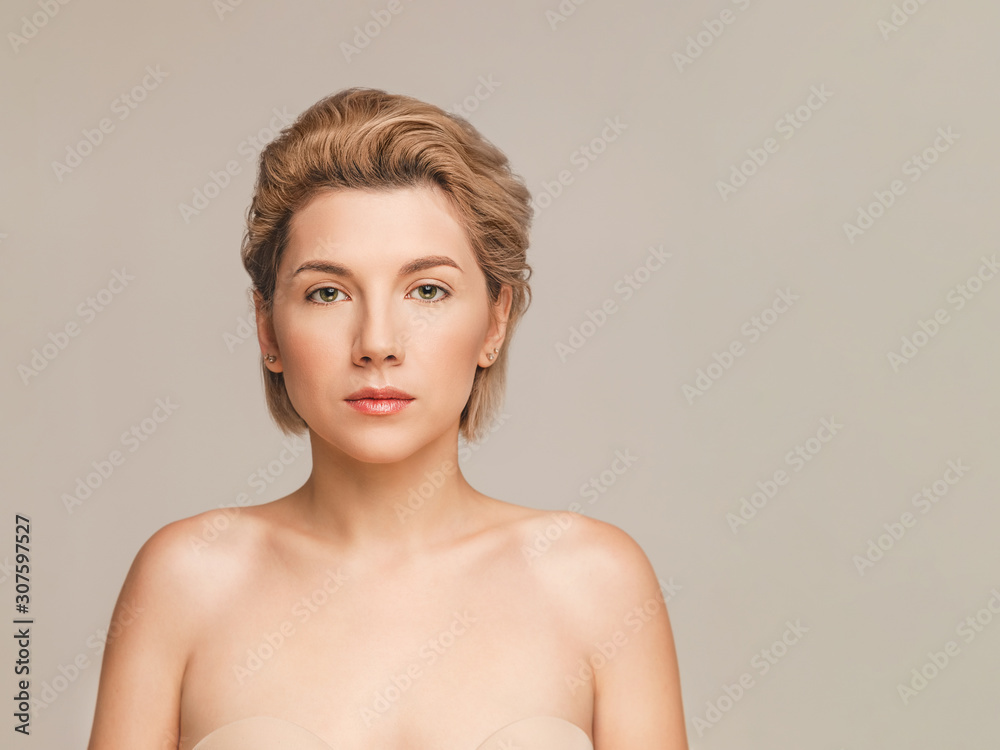 Portrait of a beautiful tender blonde model with short hair, green eyes, perfect skin, bare shoulders and natural professional makeup. Shot on a beige background in the studio. Copy space for text Portrait of a beautiful tender blonde model with short hair, green eyes, perfect skin, bare shoulders and natural professional makeup. Shot on a beige background in the studio. Copy space for text