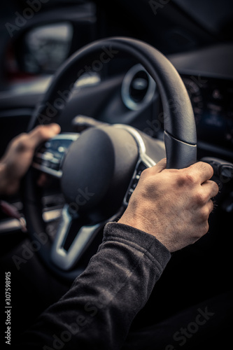 Man's hand holding the steering wheel © bizoo_n