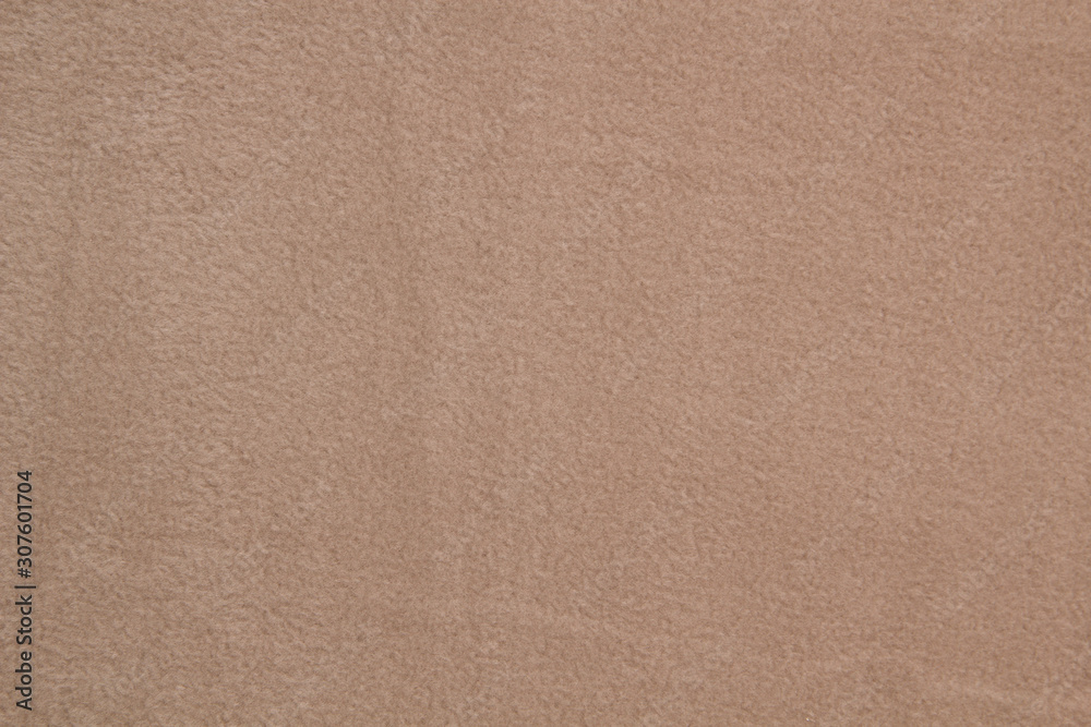 Fototapeta premium Fabric fleece beige view from the top. Texture of textile fleece bedspread.
